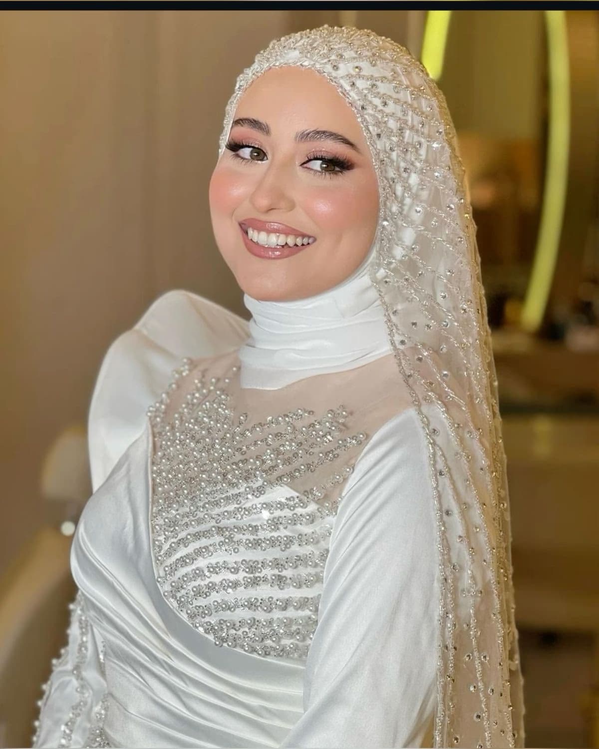 Muslim bride portrait in Sharjah with elegant modest bridal makeup and hijab styling by Elani Artistry, radiant skin and refined bridal finish