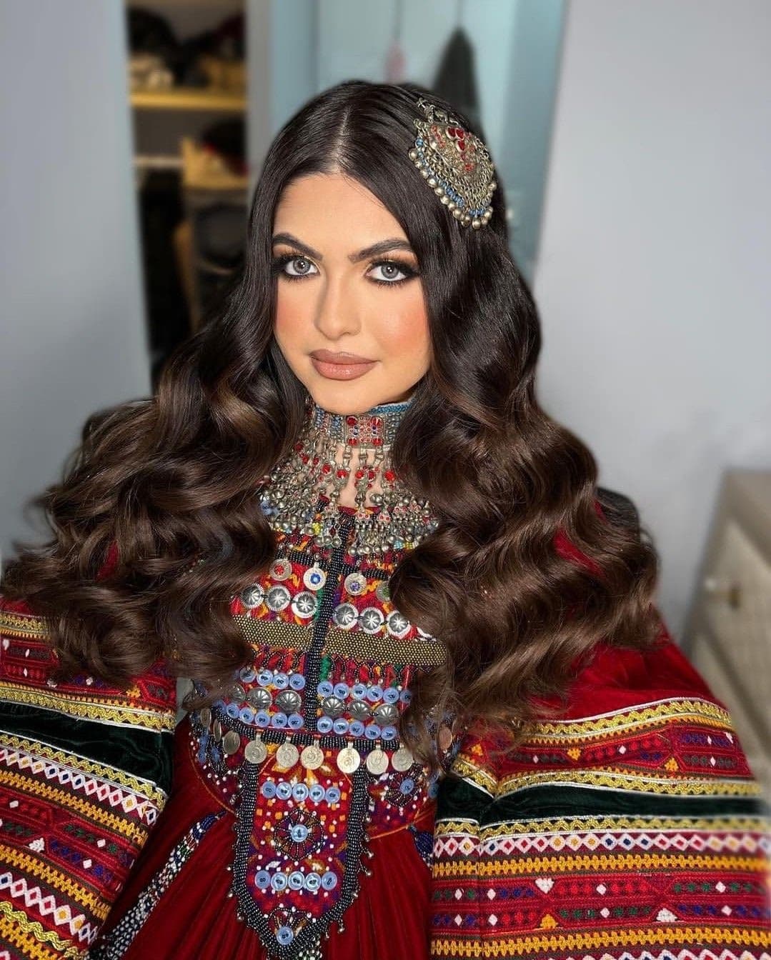 Pashtun bride with traditional embroidered dress and silver coin jewellery, glamour bridal makeup by Elani Artistry Dubai