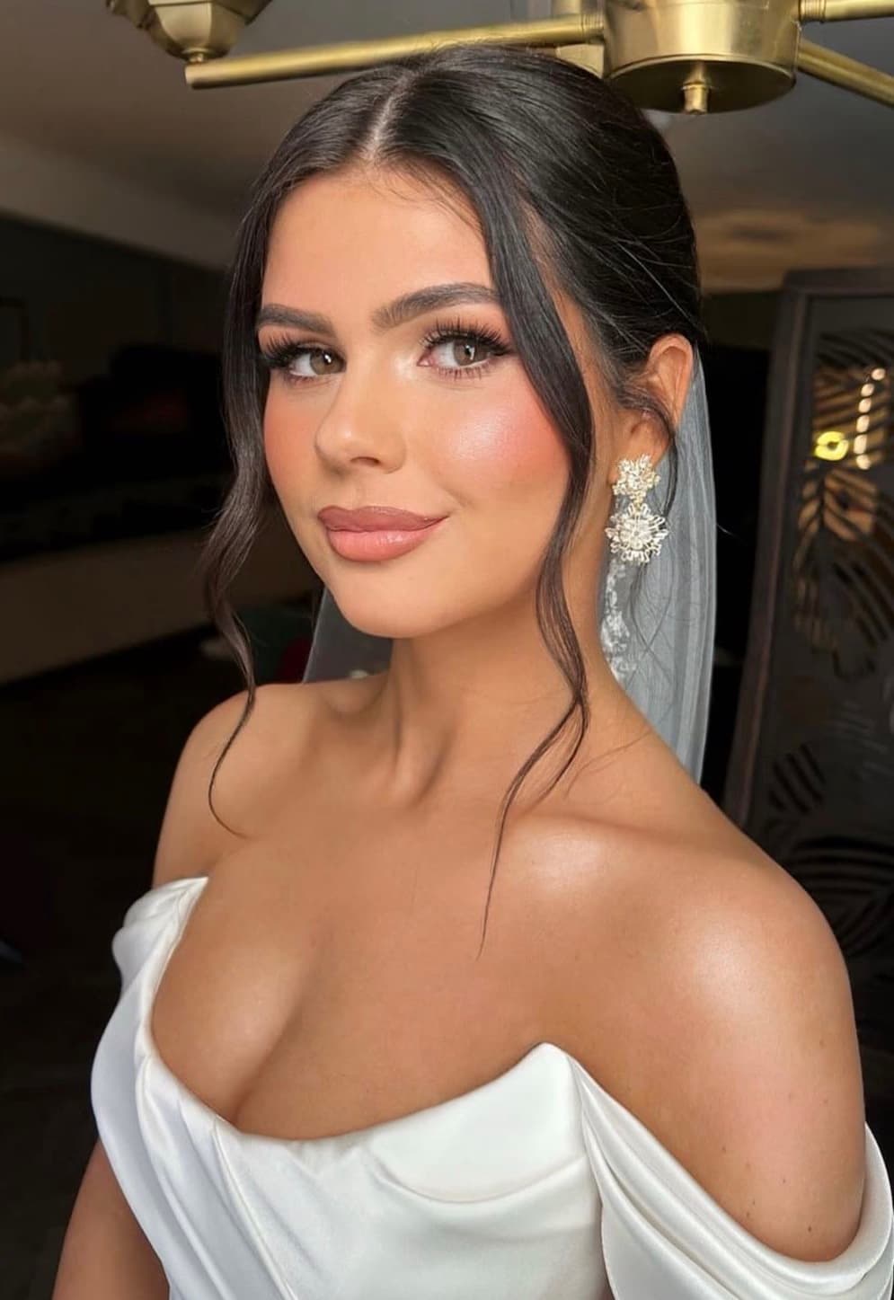 Glam Western bride in Abu Dhabi with luminous skin, sculpted features and statement lashes in off-shoulder gown by Elani Artistry
