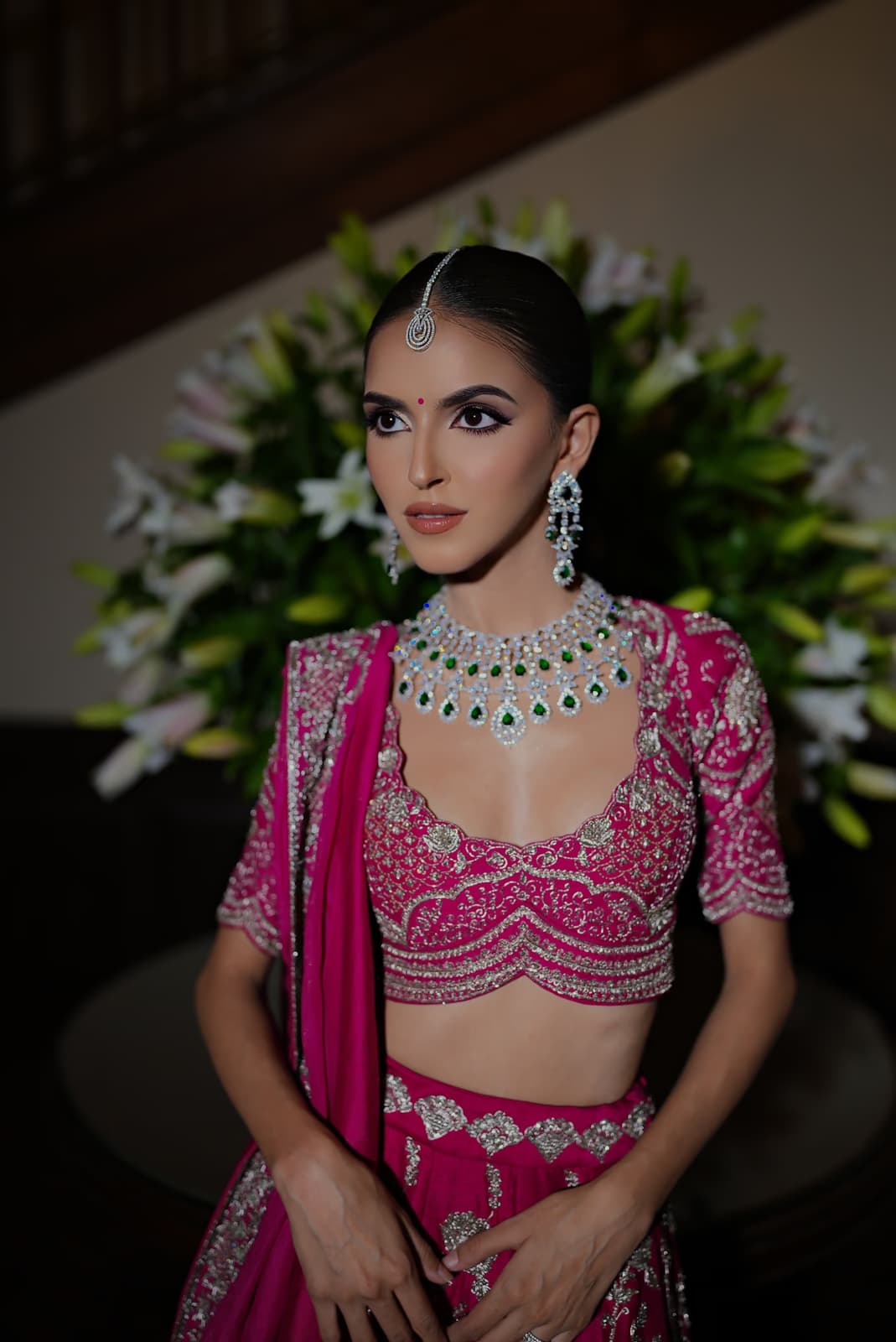Punjabi bride in Dubai at mehndi ceremony with vibrant bold bridal makeup and traditional jewellery by Elani Artistry